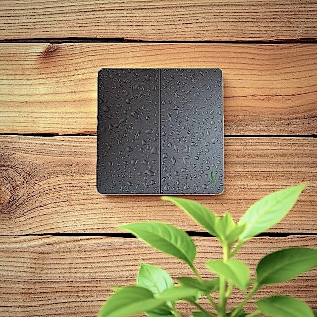 Dimi wireless switch installed in recycled wood wall and plant in front - Wireless Control Battery Free