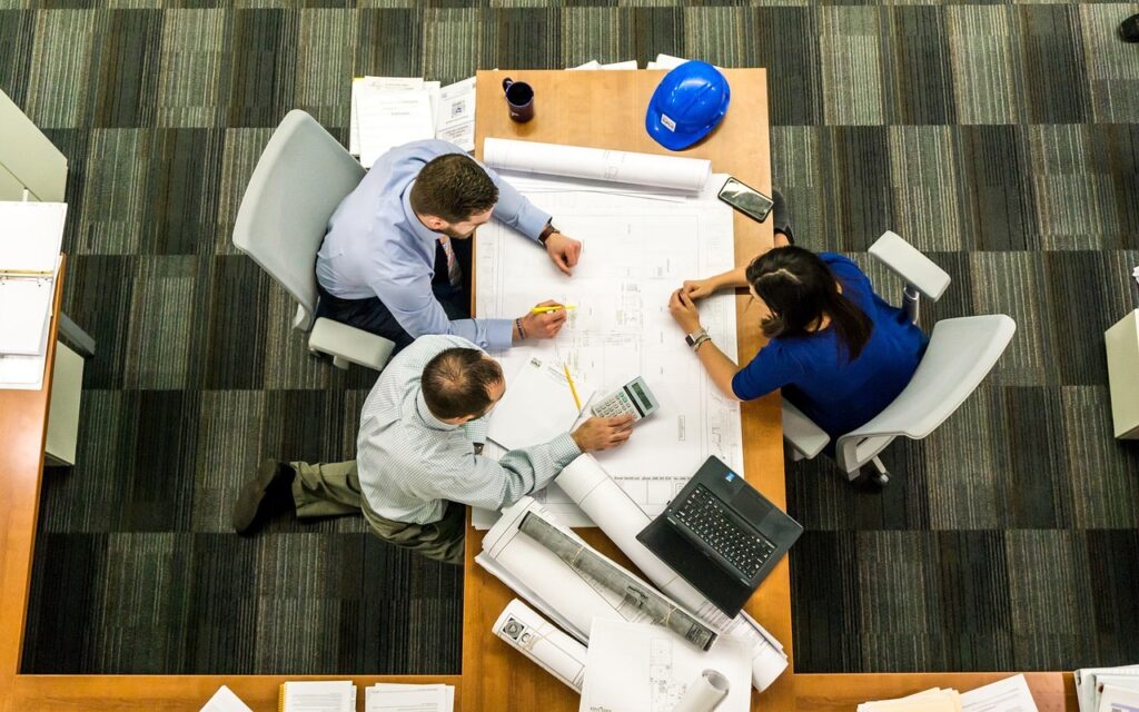Dimi team at work in a meeting table providing customer solutions for customers. Wireless Solutions for Home & Business