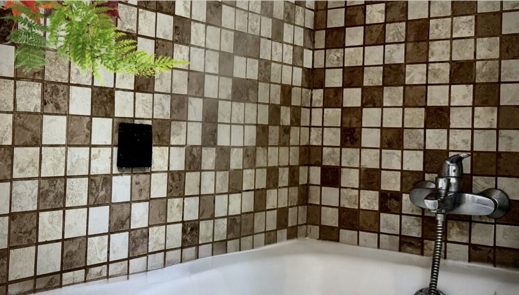 Wireless waterproof keypad installed in a bath wile water flowing on it - Smart Control Set Free